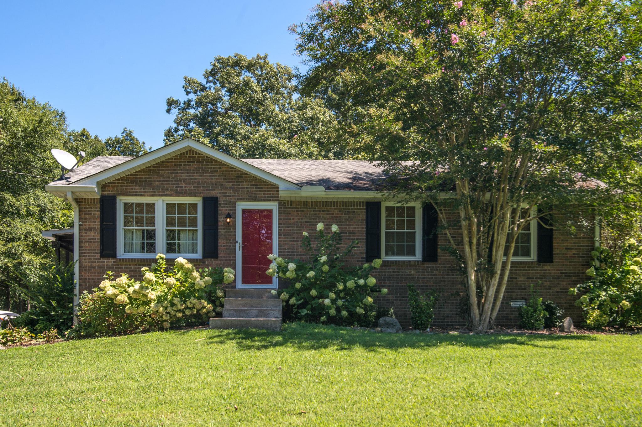 7116 Crow Cut Road Fairview, TN 37062 - Photo 1 of 30 a front view of a house with garden