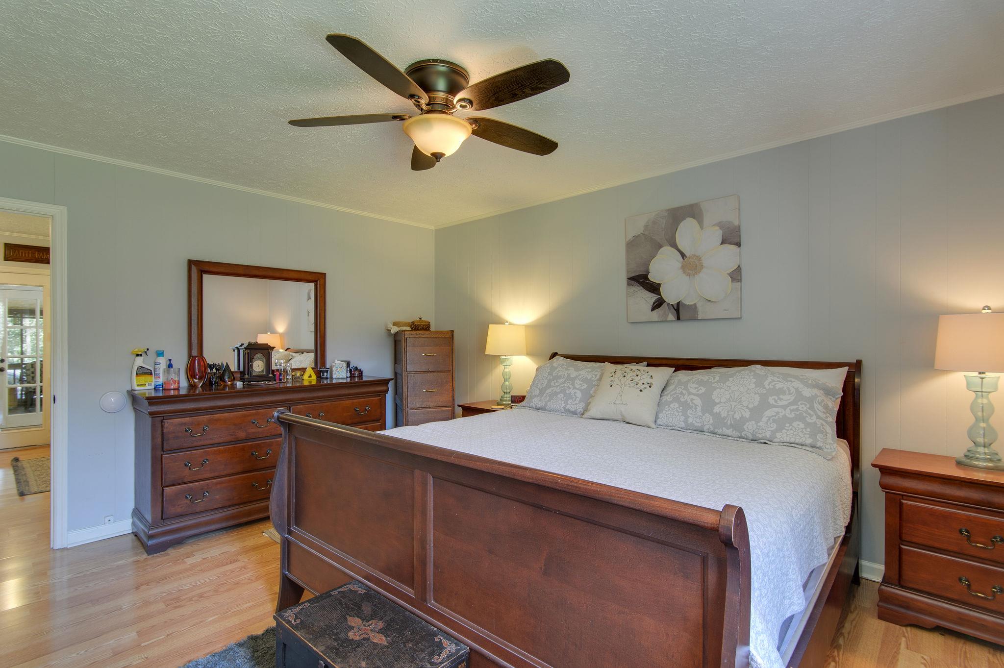 7116 Crow Cut Road Fairview, TN 37062 - Photo 16 of 30 a bed room with a bed and a chandelier