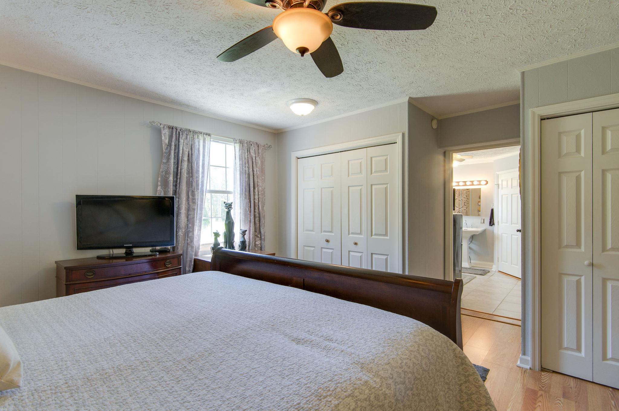 7116 Crow Cut Road Fairview, TN 37062 - Photo 17 of 30 a bedroom with a bed and a flat screen tv