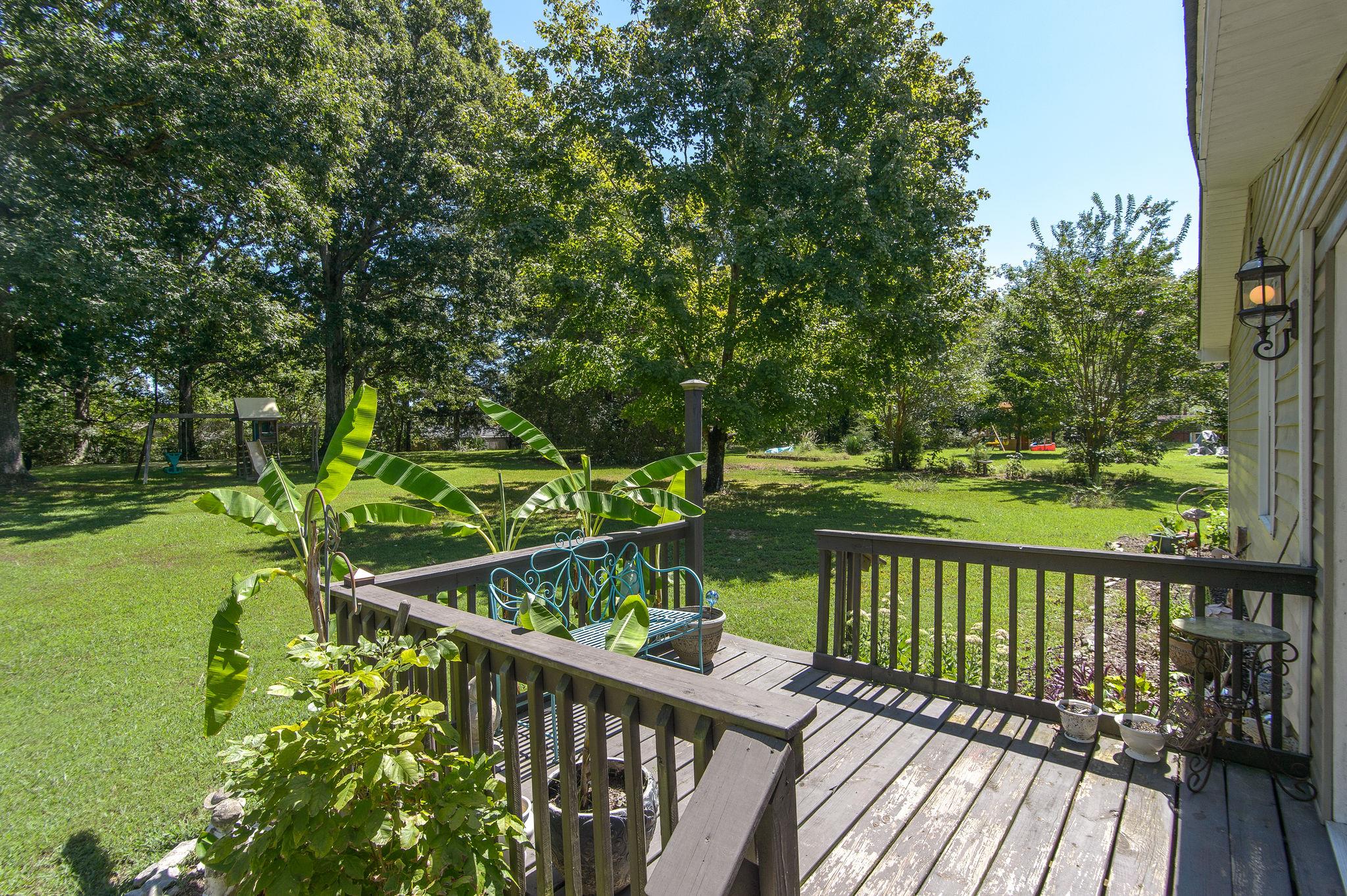 7116 Crow Cut Road Fairview, TN 37062 - Photo 27 of 30 a view of a wooden deck with a large garden