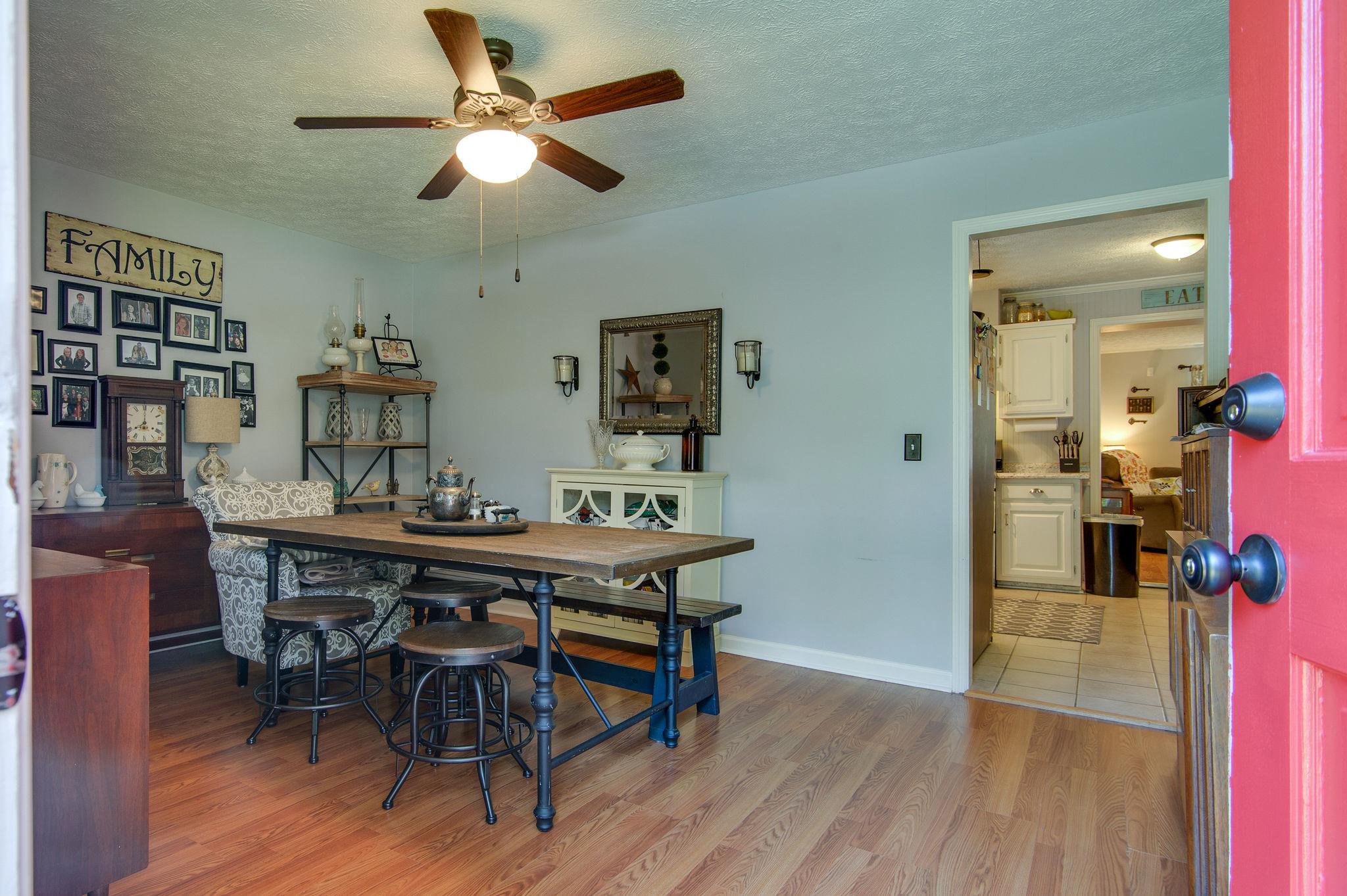 7116 Crow Cut Road Fairview, TN 37062 - Photo 3 of 30 a view of a dining room with furniture and wooden floor
