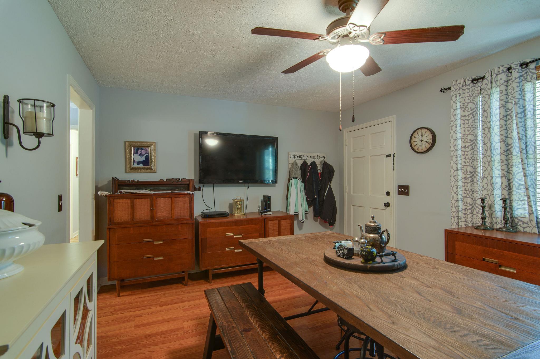 7116 Crow Cut Road Fairview, TN 37062 - Photo 6 of 30 a view of a workspace with furniture and a flat screen tv