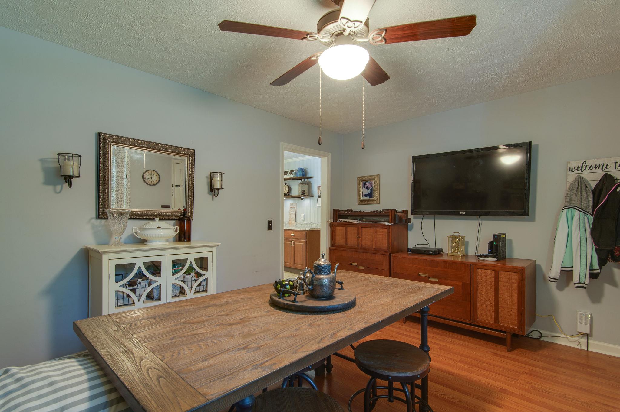 7116 Crow Cut Road Fairview, TN 37062 - Photo 7 of 30 a view of a dining room with furniture and wooden floor