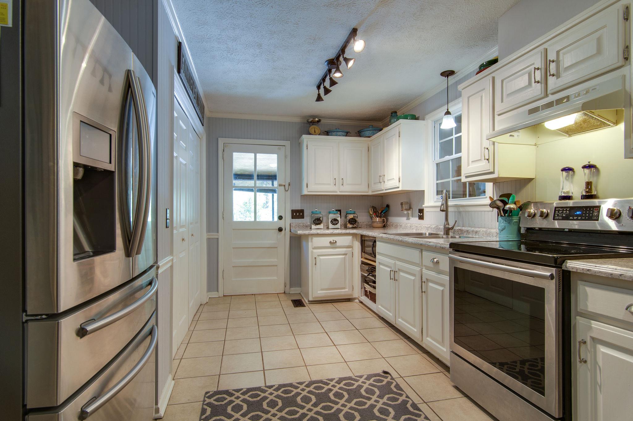 7116 Crow Cut Road Fairview, TN 37062 - Photo 8 of 30 a kitchen with a stove a sink and a refrigerator