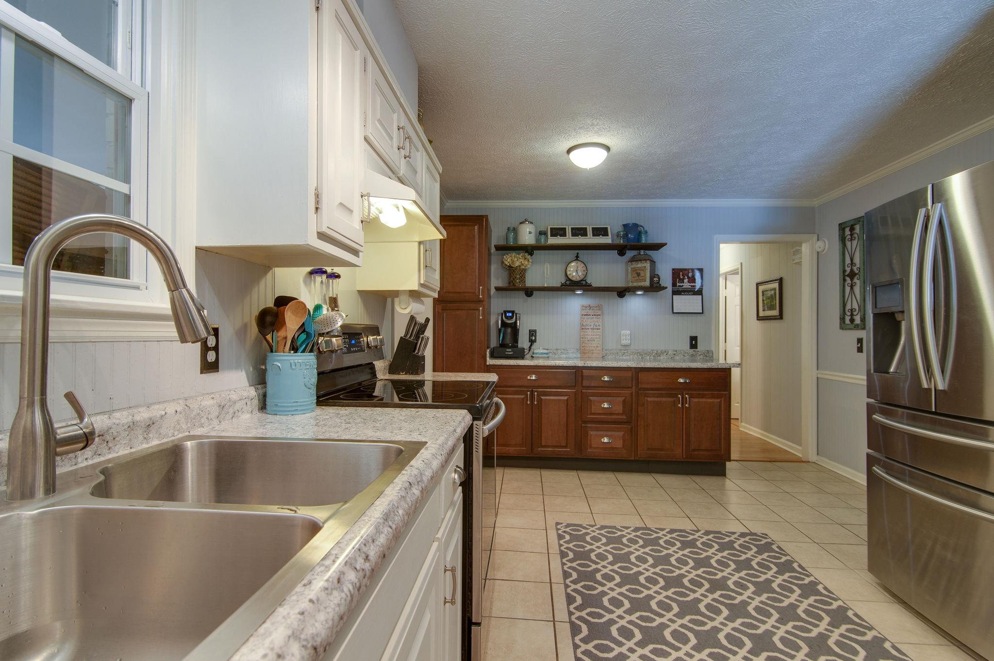 7116 Crow Cut Road Fairview, TN 37062 - Photo 9 of 30 a large kitchen with a sink a counter top space and stainless steel appliances
