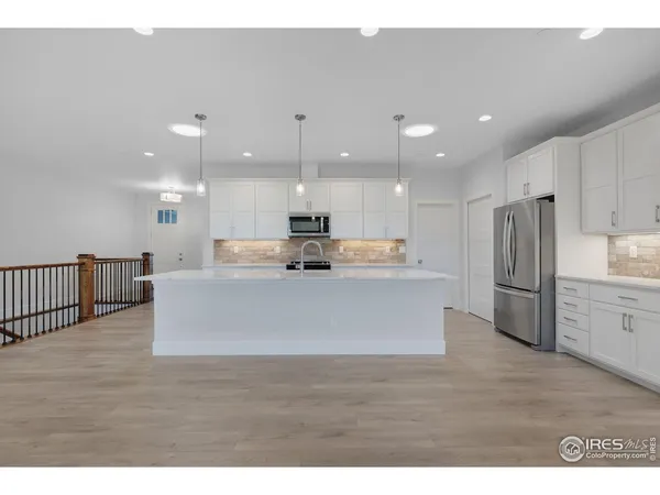 a view of a kitchen with a sink cabinets and a fireplace