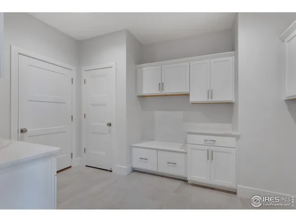 a kitchen with white cabinets and a sink