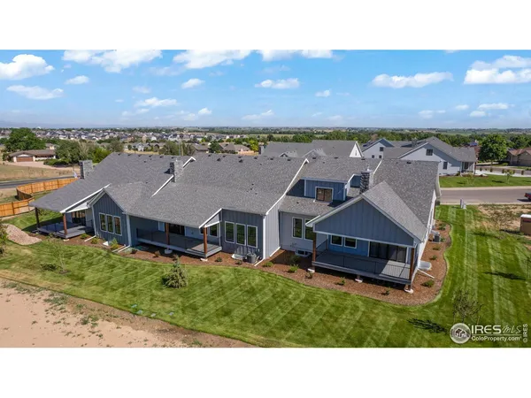 an aerial view of a house with a garden and a yard