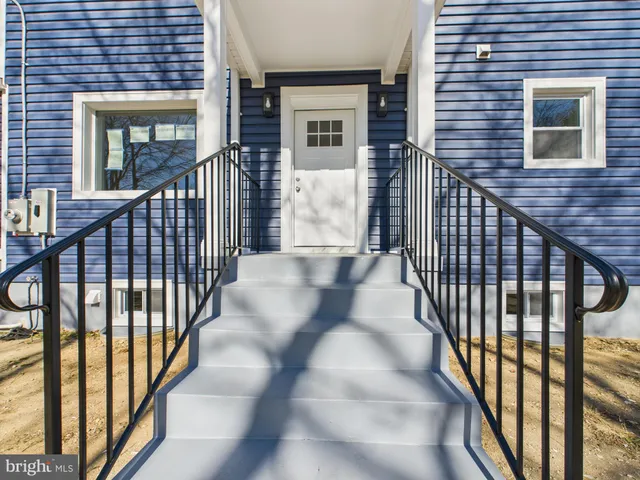 a big house with large trees in front of it