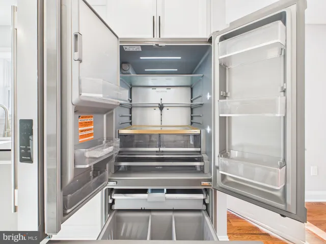 a kitchen with stainless steel appliances a refrigerator sink and cabinets
