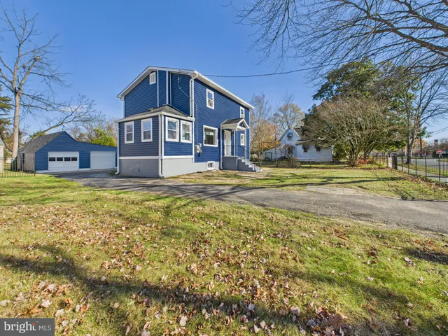 a big house with a big yard and large trees