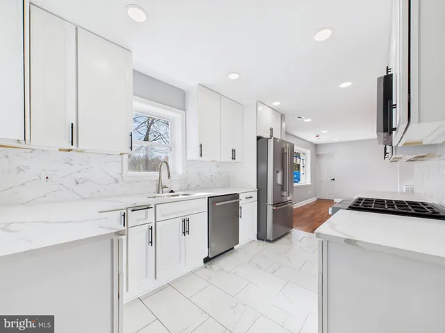 a kitchen with a sink stove and refrigerator