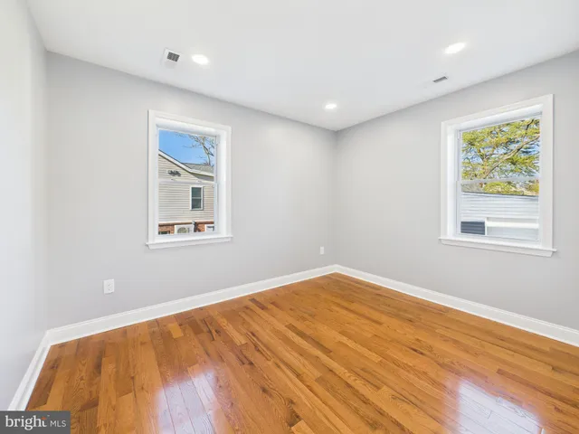 a kitchen with granite countertop white cabinets and stainless steel appliances