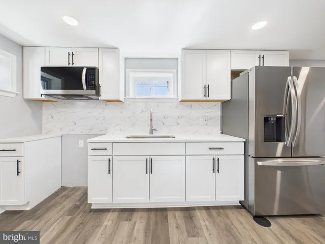 a utility room with sink dryer and washer