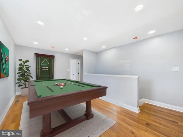 a room with pool table and windows