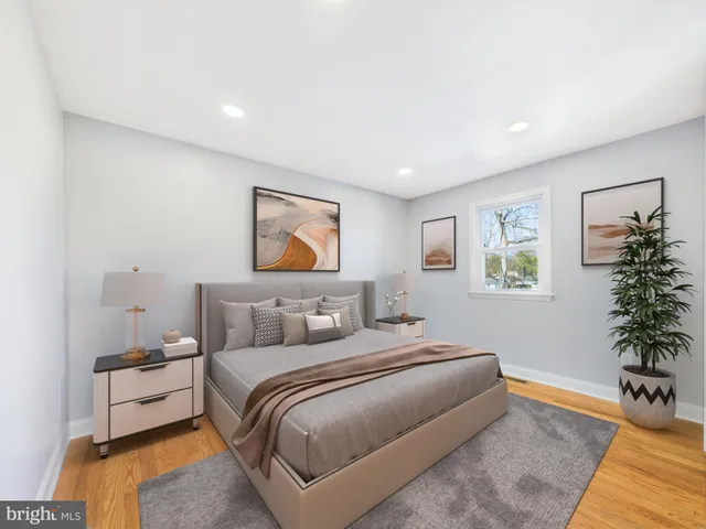 a bedroom with a bed and a potted plant