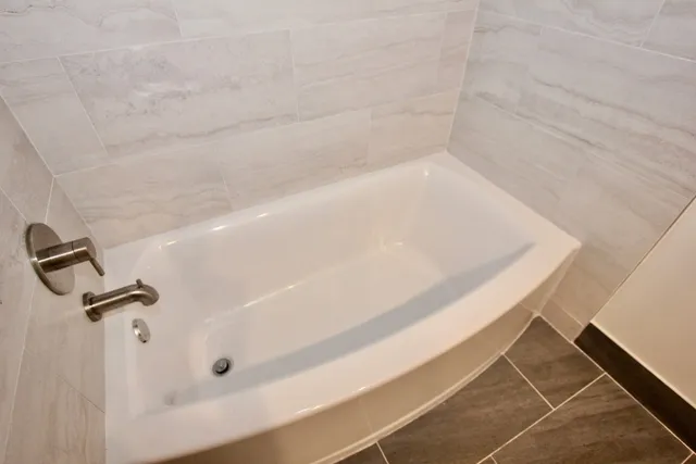 a bathroom with a sink a mirror and a bathtub