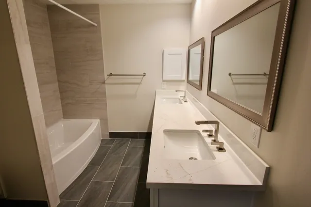 an empty room with a ceiling fan and carpet