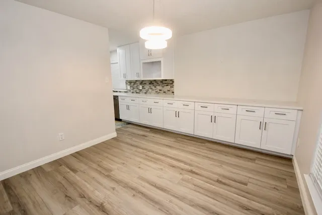 a view of a kitchen with wooden floor