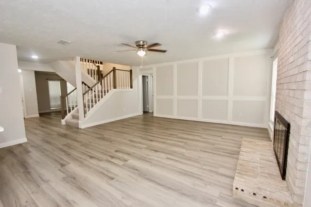 a front view of a house with a yard and potted plants