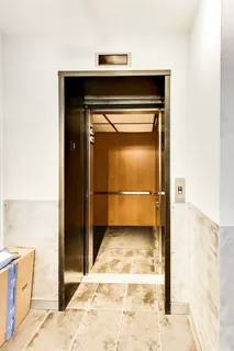 a living room with fireplace furniture and a large window