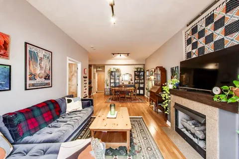 a living room with furniture and a dining table