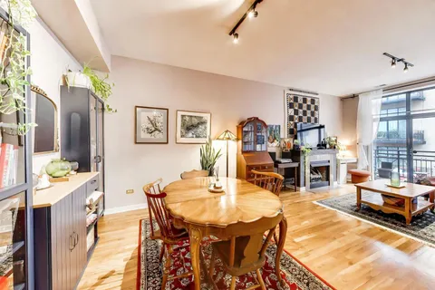 a dining room with furniture and a chandelier