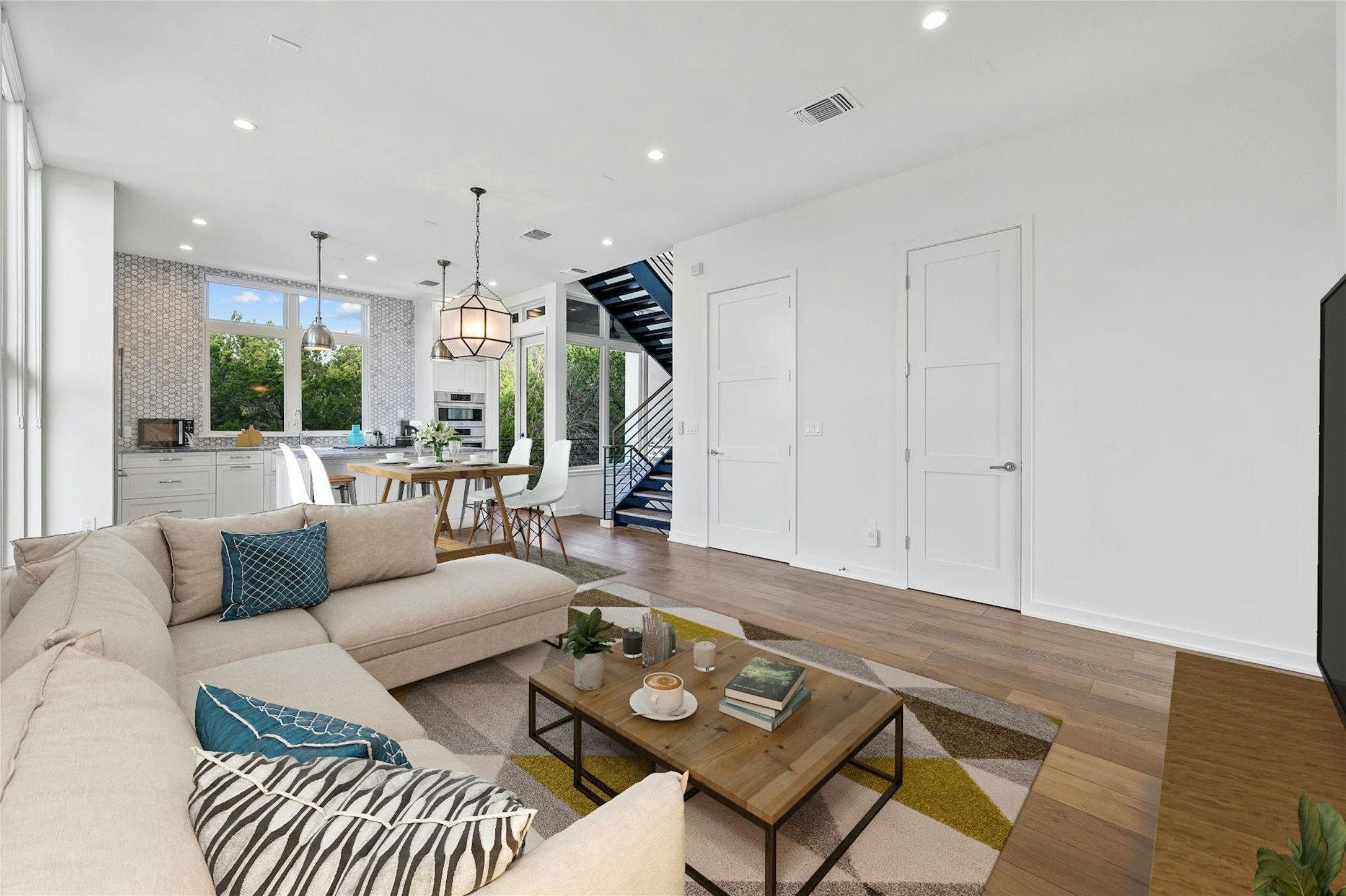 2518 Sutherland Street Austin, TX 78746 - Photo 4 of 30 Hardwood floors stretch across this living space, offering a clean, contemporary aesthetic with natural light.
