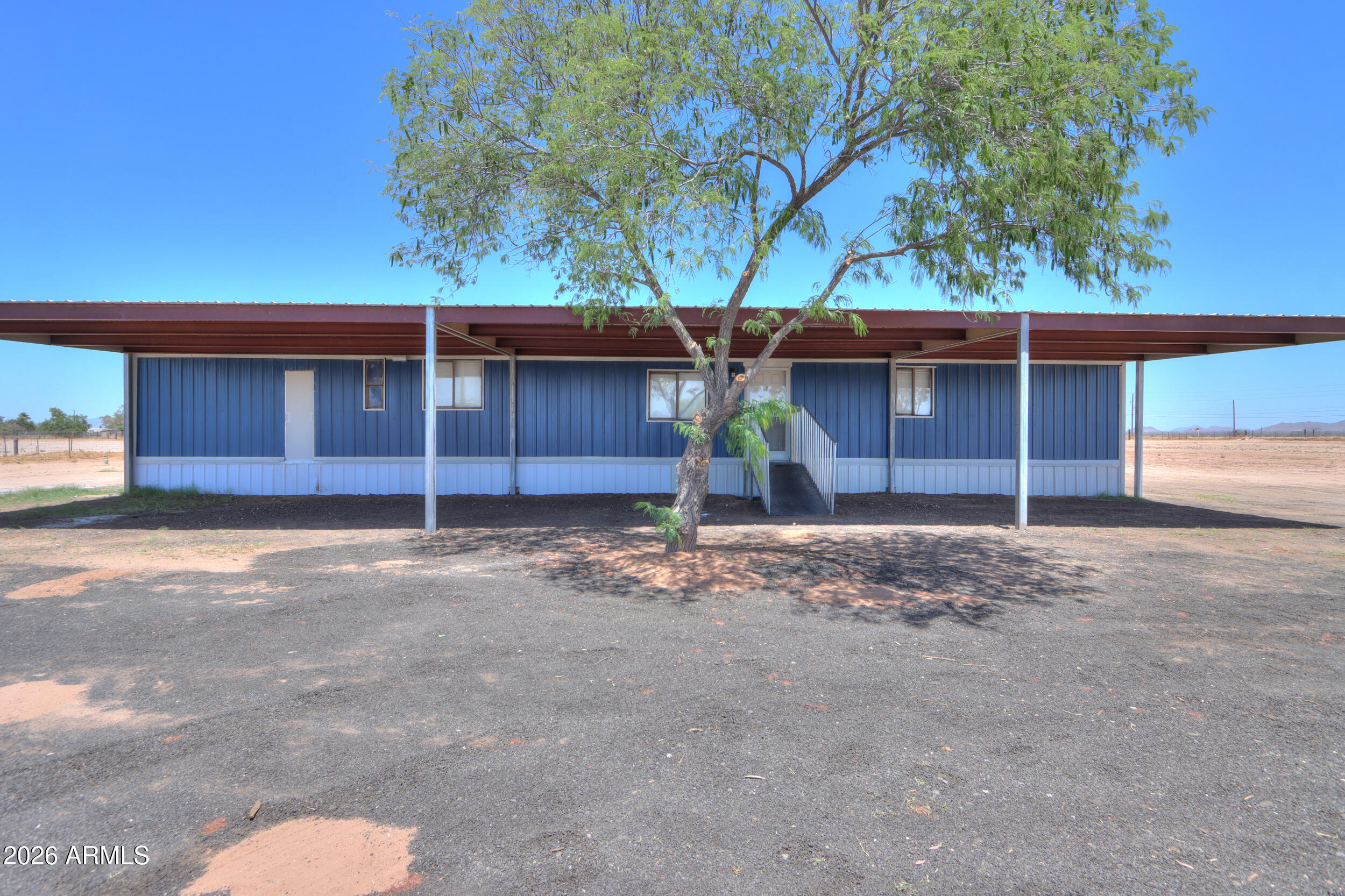 33776 West Siesta Road Stanfield, AZ 85172 - Photo 8 of 54 a front view of a house with a yard and garage