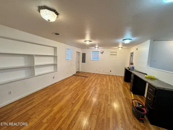 a view of a room with wooden floor and staircase