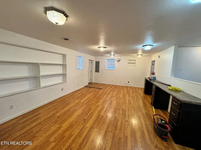 a view of a room with wooden floor and staircase
