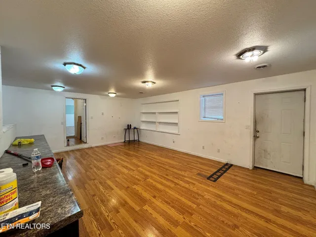 a room with a bed and furniture with wooden floor