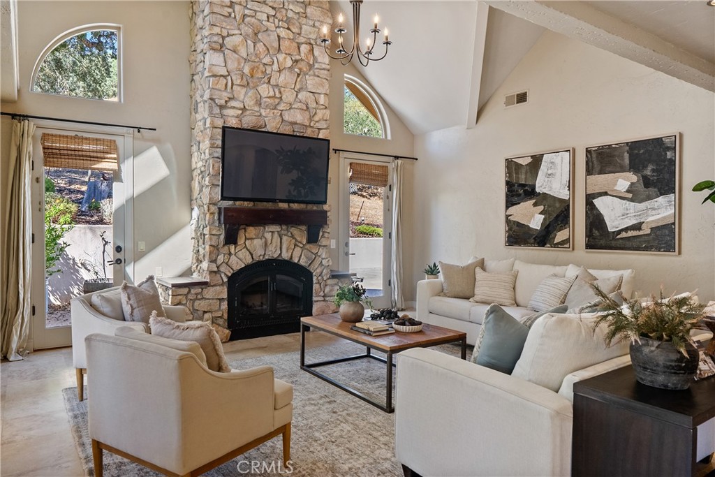 6360 Navarette Avenue Atascadero, CA 93422 - Photo 16 of 75 a living room with furniture a fireplace and a flat screen tv