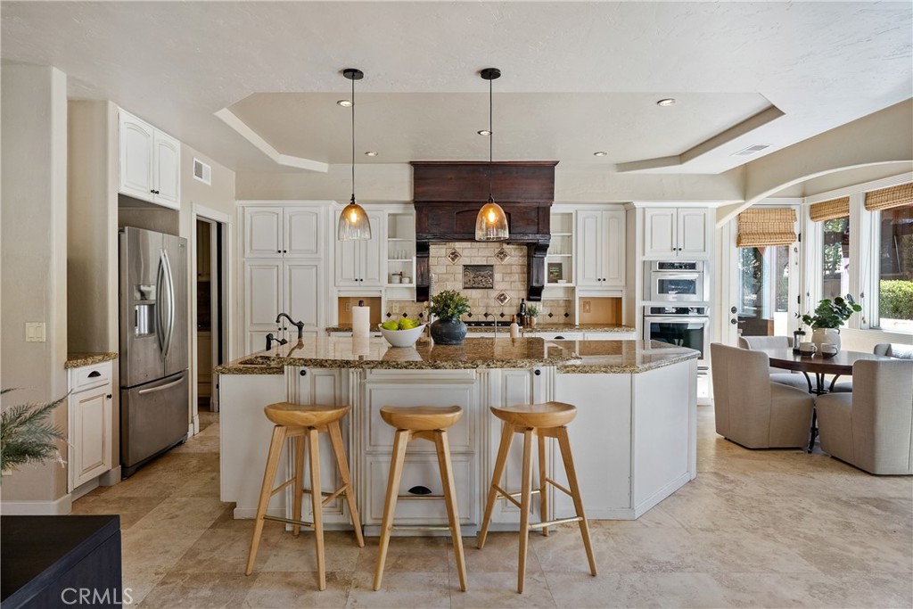 6360 Navarette Avenue Atascadero, CA 93422 - Photo 18 of 75 a kitchen with stainless steel appliances kitchen island granite countertop dining table chairs and granite counter tops