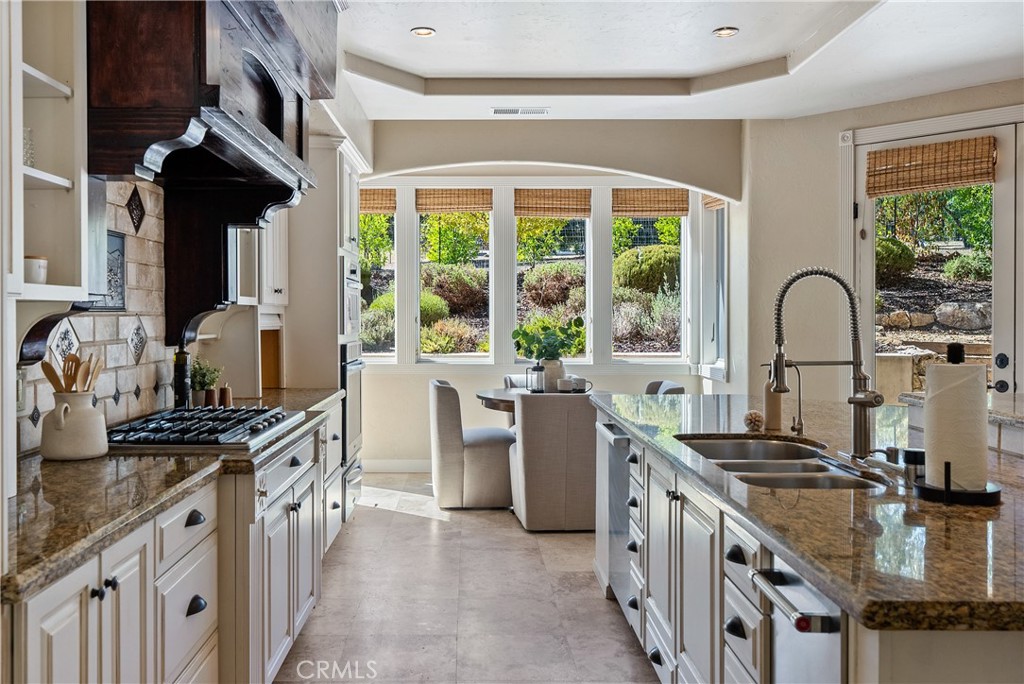 6360 Navarette Avenue Atascadero, CA 93422 - Photo 22 of 75 a kitchen with stainless steel appliances granite countertop a stove a sink and a refrigerator