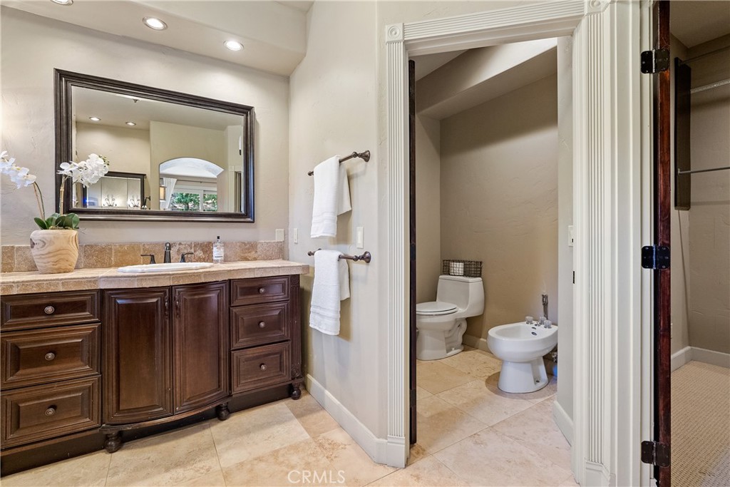 6360 Navarette Avenue Atascadero, CA 93422 - Photo 37 of 75 a bathroom with a toilet a sink and mirror