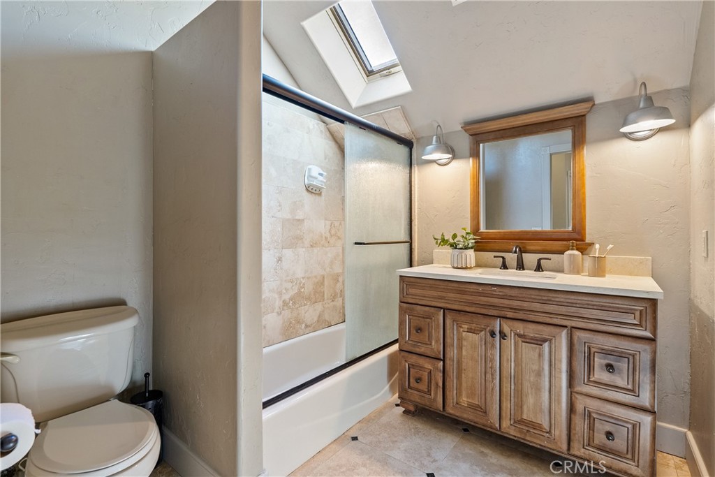 6360 Navarette Avenue Atascadero, CA 93422 - Photo 42 of 75 a bathroom with a granite countertop toilet a sink and a mirror