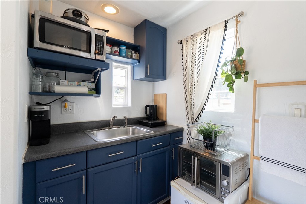 6360 Navarette Avenue Atascadero, CA 93422 - Photo 61 of 75 a kitchen with stainless steel appliances granite countertop a sink a stove a microwave a refrigerator and cabinets