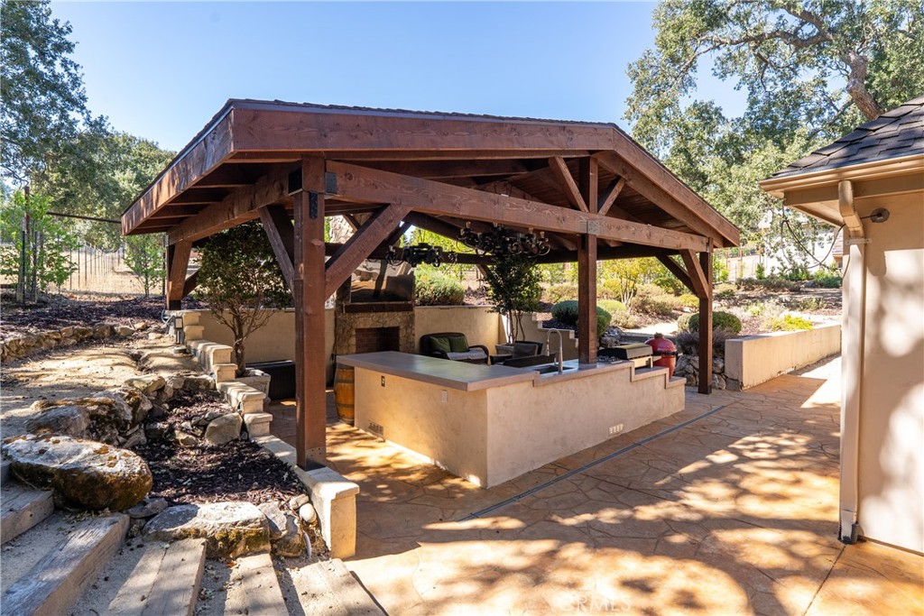 6360 Navarette Avenue Atascadero, CA 93422 - Photo 68 of 75 a view of a patio with table and chairs under an umbrella