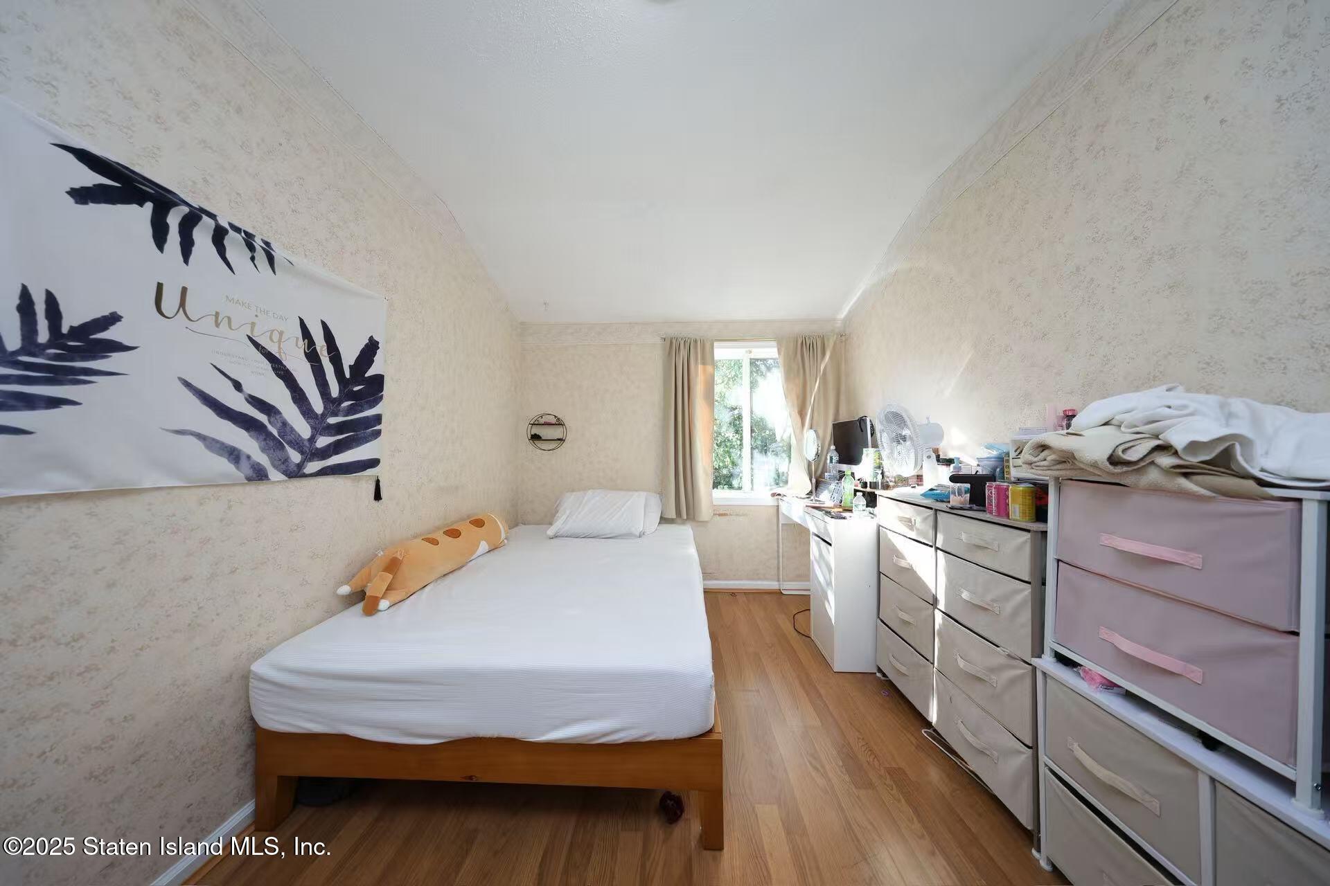 78 Emily Lane Staten Island, NY 10312 - Photo 14 of 24 a bedroom with furniture and a wooden floor