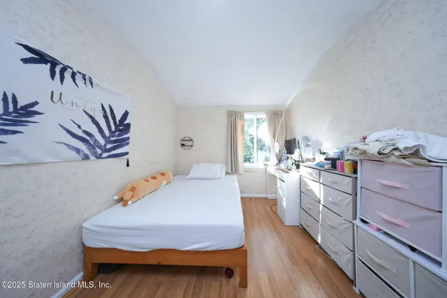 a bedroom with furniture and a wooden floor