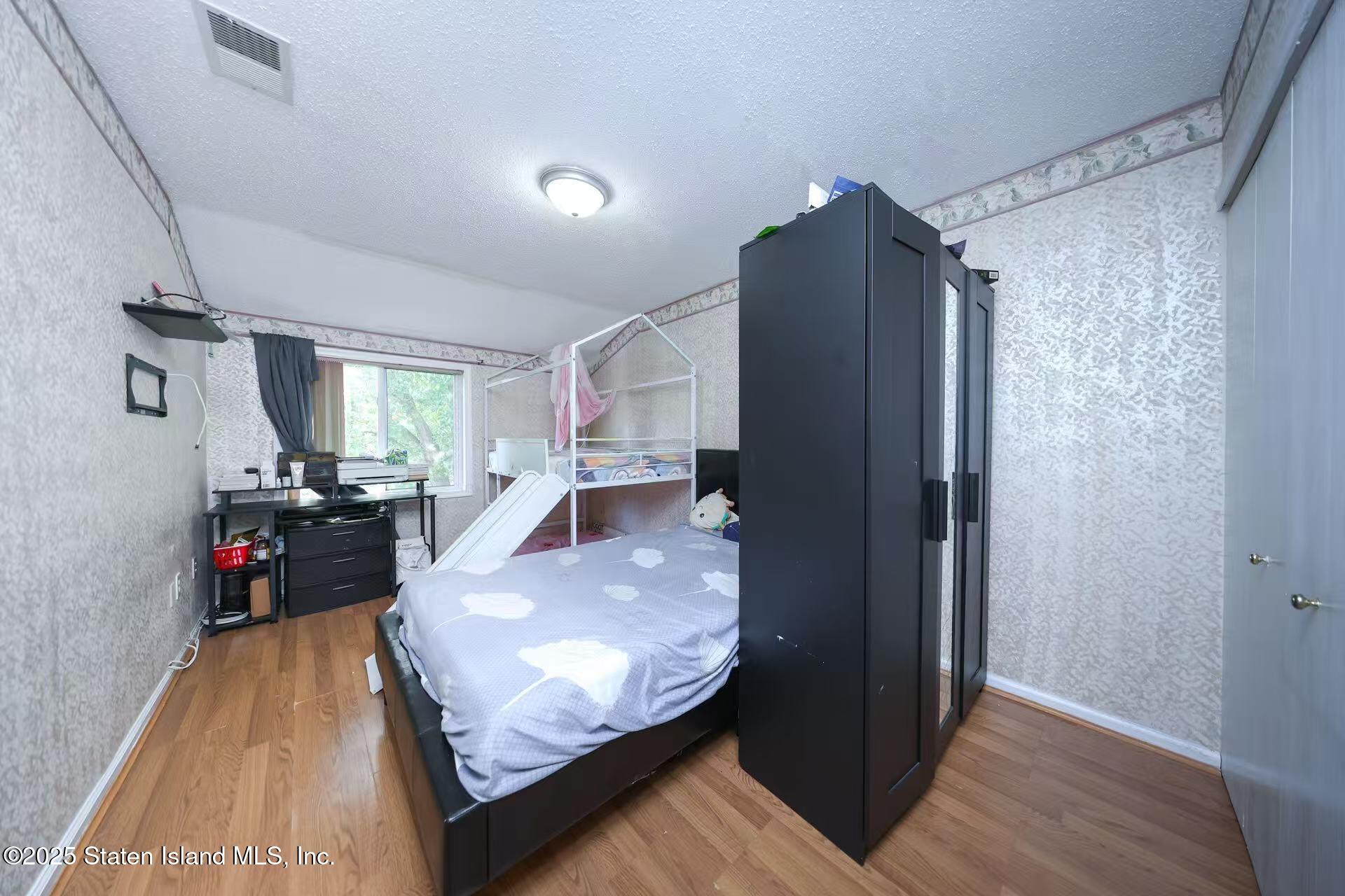 78 Emily Lane Staten Island, NY 10312 - Photo 18 of 24 a living room with furniture and a flat screen tv