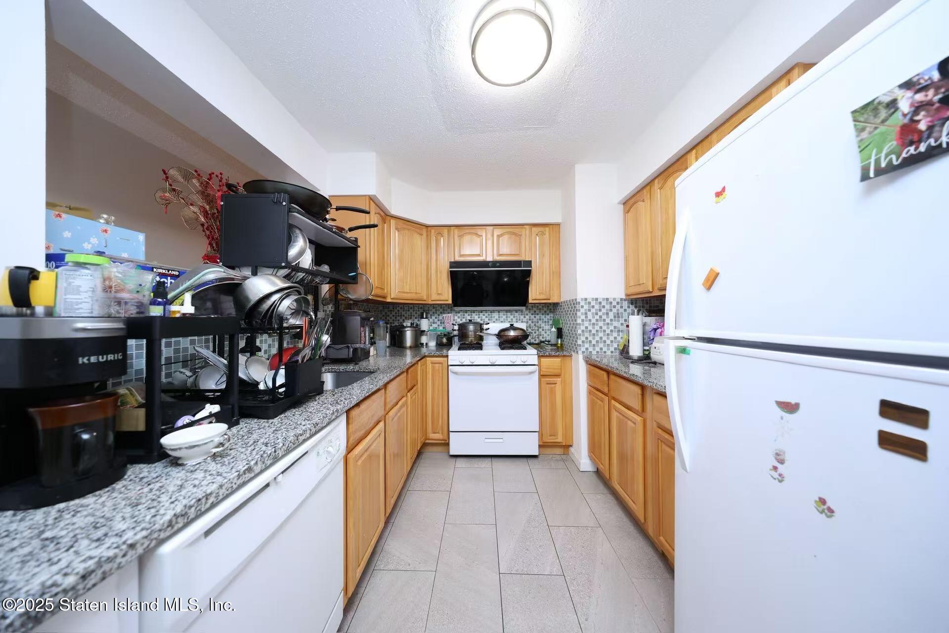 78 Emily Lane Staten Island, NY 10312 - Photo 7 of 24 a kitchen with granite countertop lots of counter top space