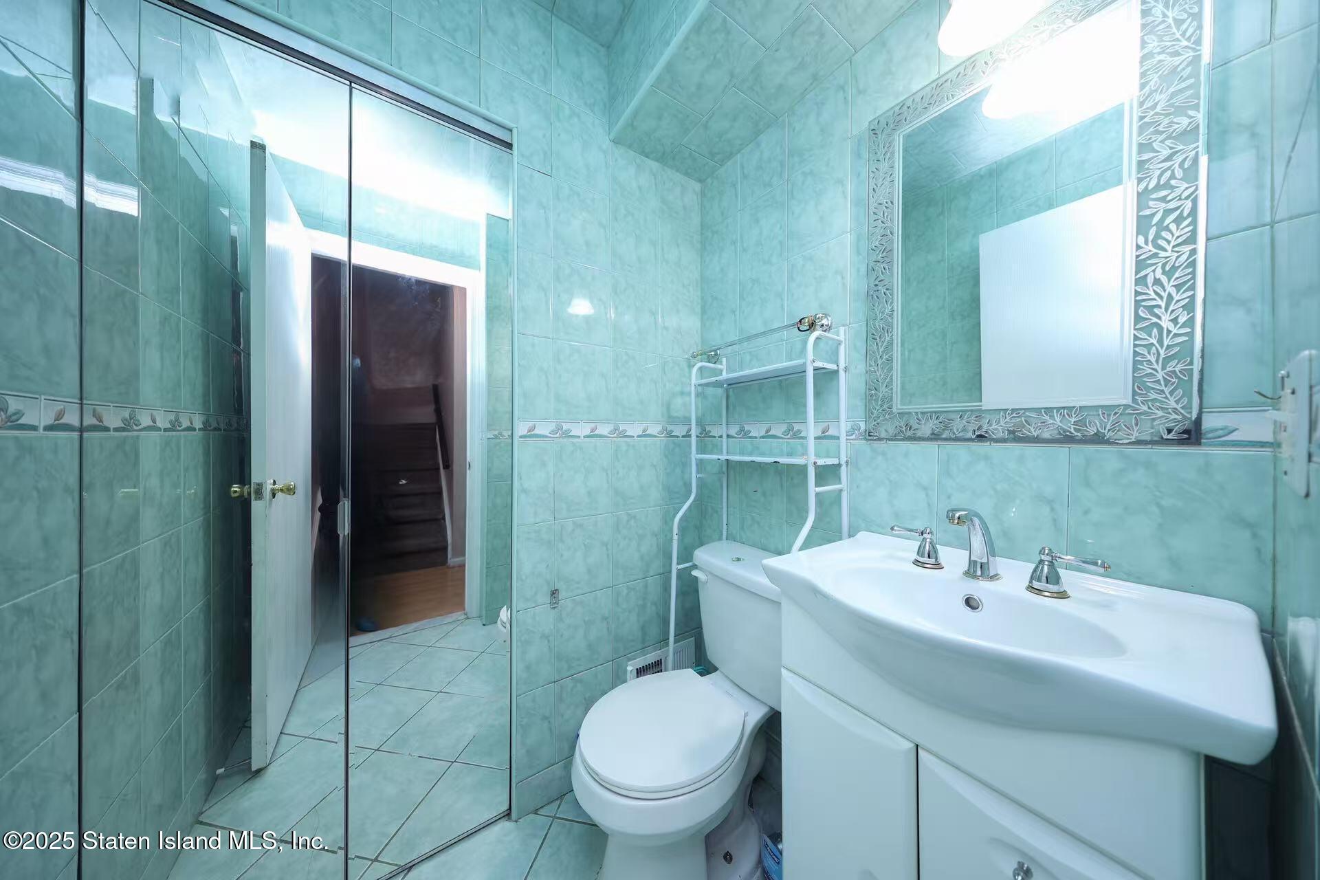 78 Emily Lane Staten Island, NY 10312 - Photo 8 of 24 a bathroom with a sink toilet and shower