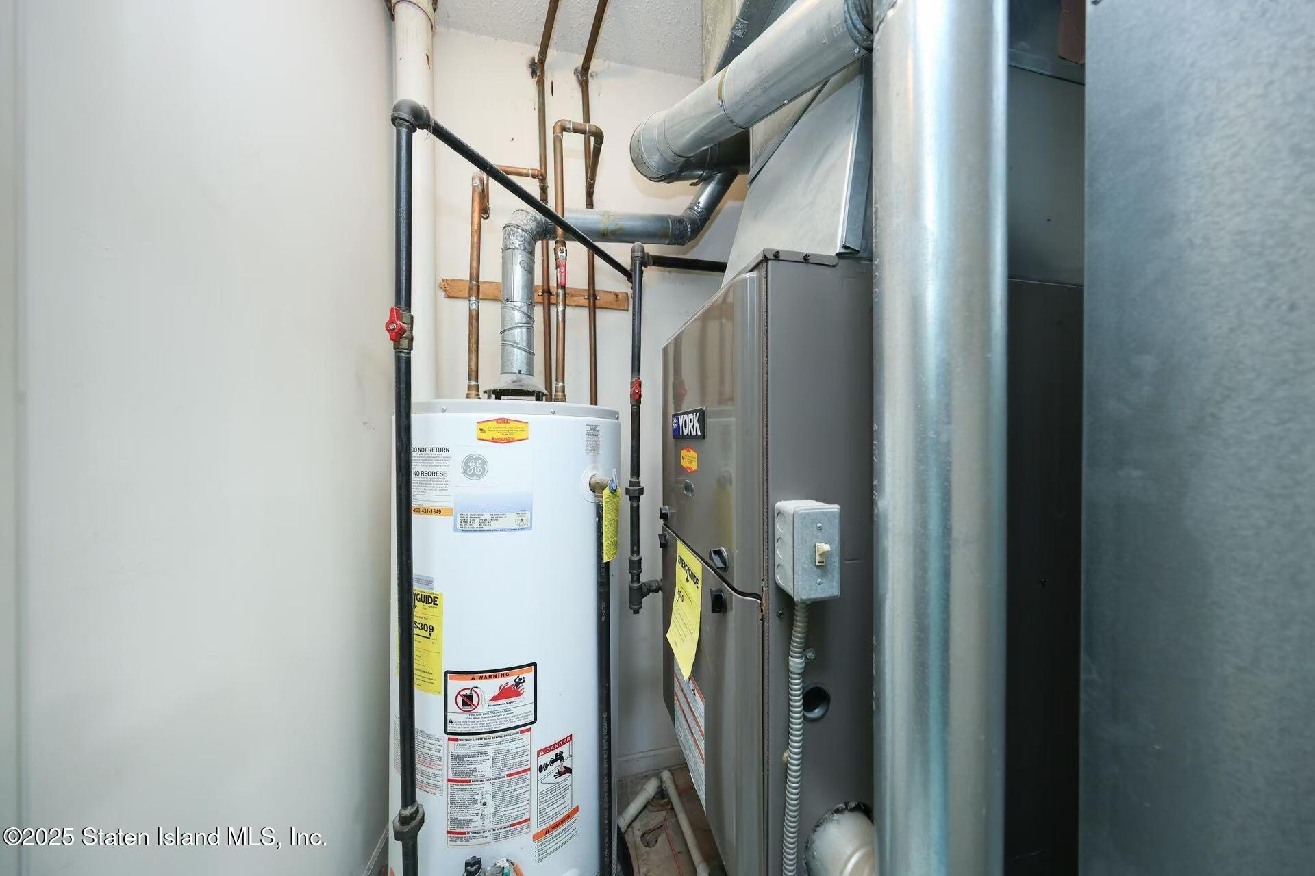 78 Emily Lane Staten Island, NY 10312 - Photo 9 of 24 a view of hallway with stairs and wooden floor