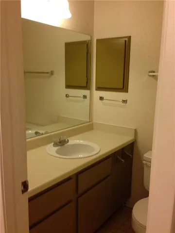 a bathroom with a sink toilet and mirror