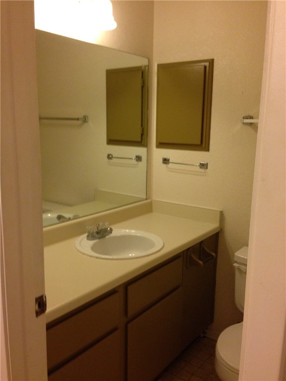 1110 Spring Loop, Unit C College Station, TX 77840 - Photo 5 of 6 a bathroom with a sink toilet and mirror