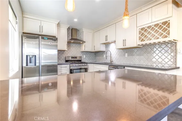 a kitchen with counter top space cabinets and stainless steel appliances