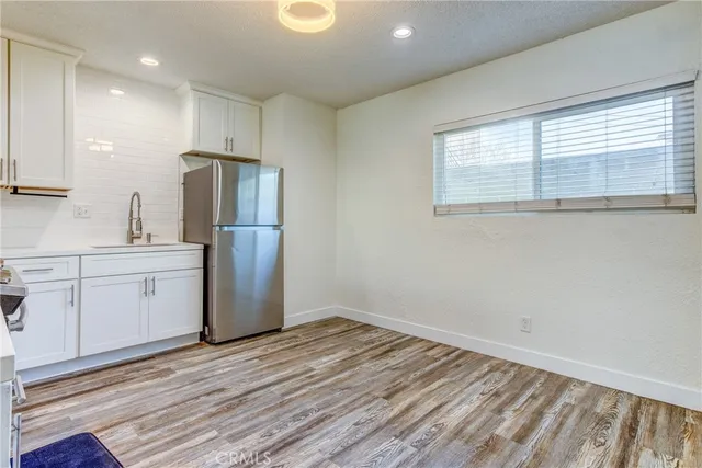 a kitchen with a refrigerator sink and cabinets