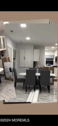 a living room with furniture a table and chairs